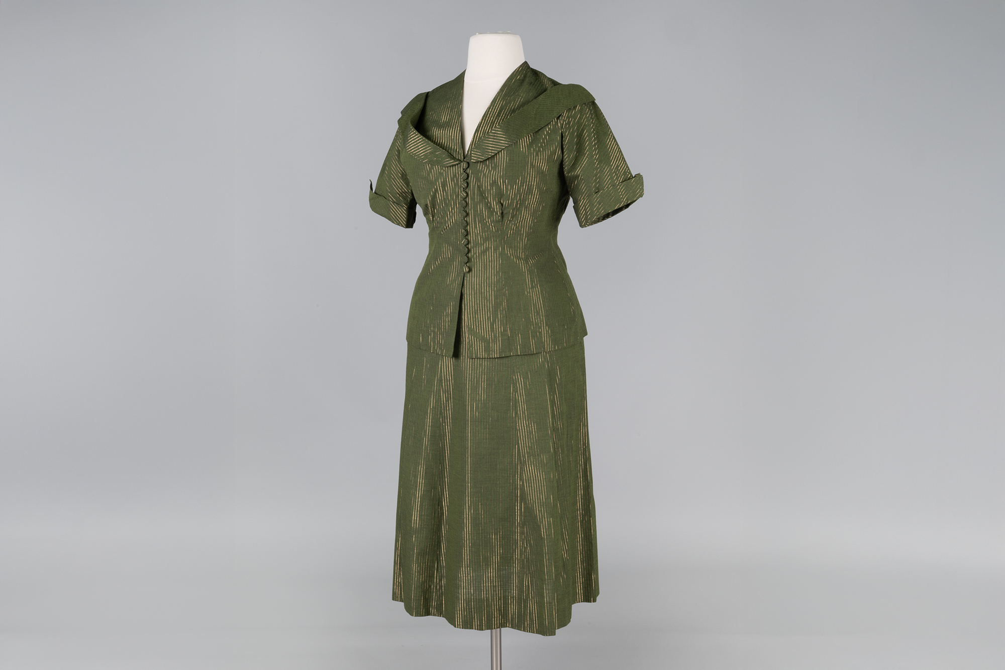 Image of Green skirt suit with gold stripes, ca. 1950